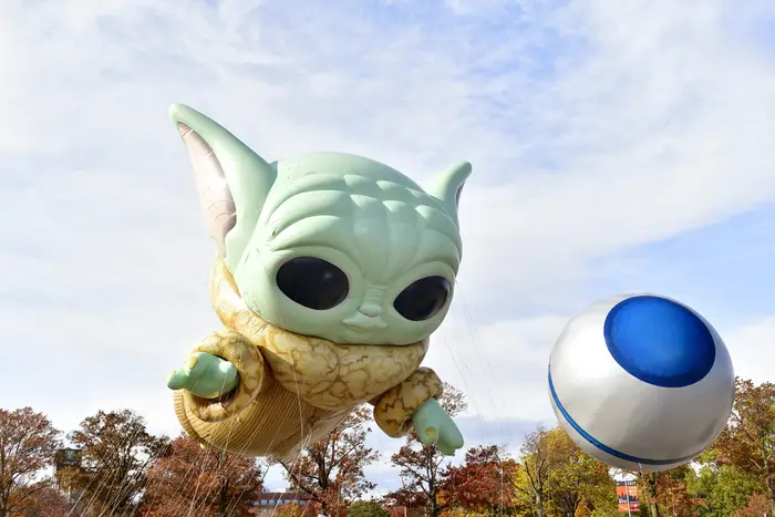 A huge balloon of Baby Yoda is flown in the air